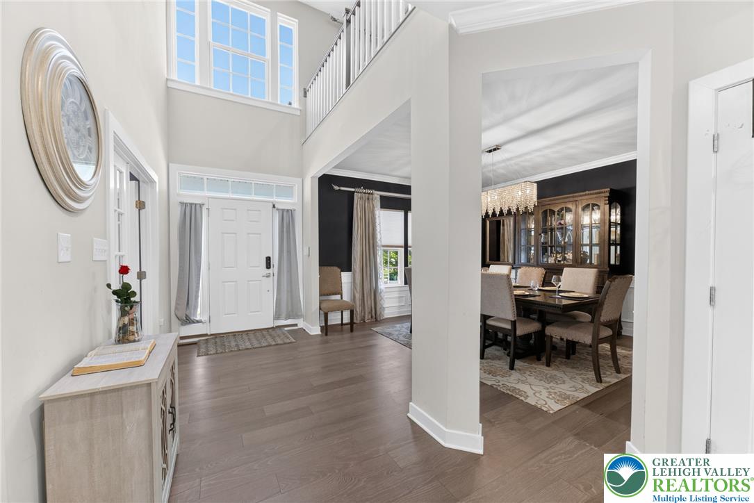 3952 Orth Street Bethlehem, PA 18020 - Photo 7 of 60 A grand entrance welcomes you home, showcasing high ceilings and rich wood flooring leading into a refined dining area.