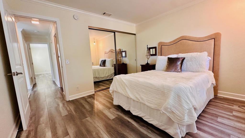 1034 Turnstone Way Oceanside, CA 92057 - Photo 11 of 25 a bedroom with a bed and a large mirror next to a window