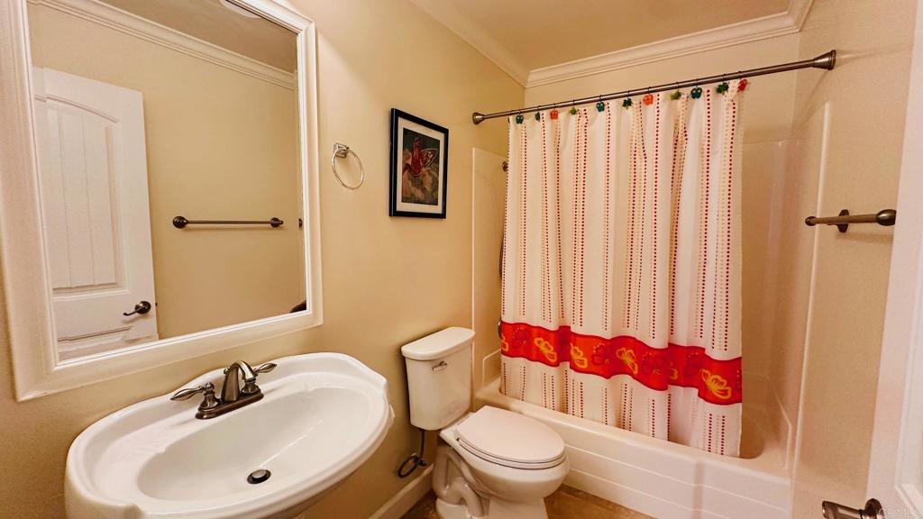 1034 Turnstone Way Oceanside, CA 92057 - Photo 12 of 25 a bathroom with a toilet a sink and a mirror