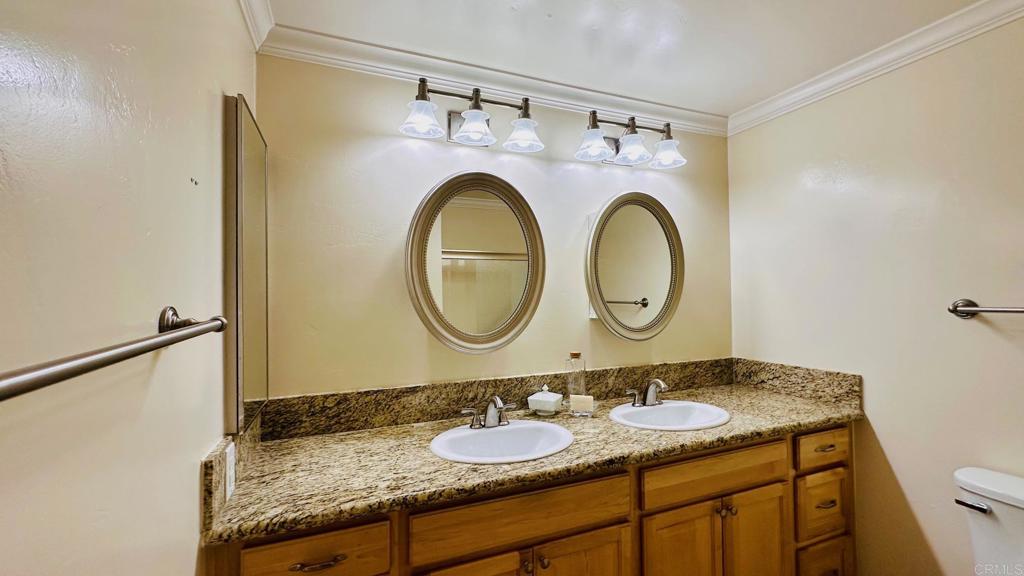 1034 Turnstone Way Oceanside, CA 92057 - Photo 15 of 25 a bathroom with a granite countertop double vanity sink and a mirror