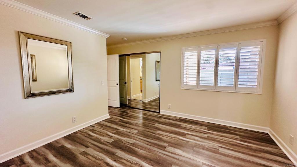 1034 Turnstone Way Oceanside, CA 92057 - Photo 16 of 25 a view of an empty room with wooden floor and a window