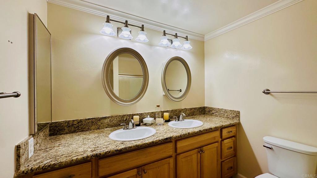 1034 Turnstone Way Oceanside, CA 92057 - Photo 17 of 28 a bathroom with a granite countertop double vanity sink and a mirror