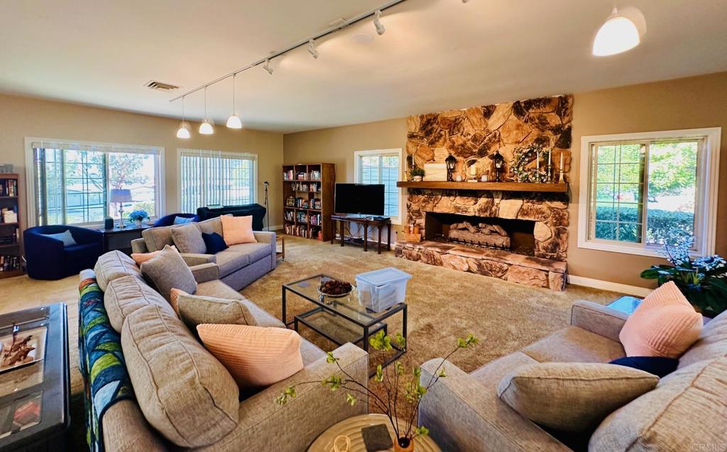 1034 Turnstone Way Oceanside, CA 92057 - Photo 21 of 25 a living room with furniture a flat screen tv and a large window