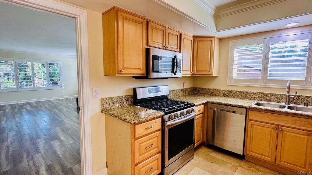 1034 Turnstone Way Oceanside, CA 92057 - Photo 3 of 25 a kitchen with stainless steel appliances granite countertop a stove a sink and a microwave