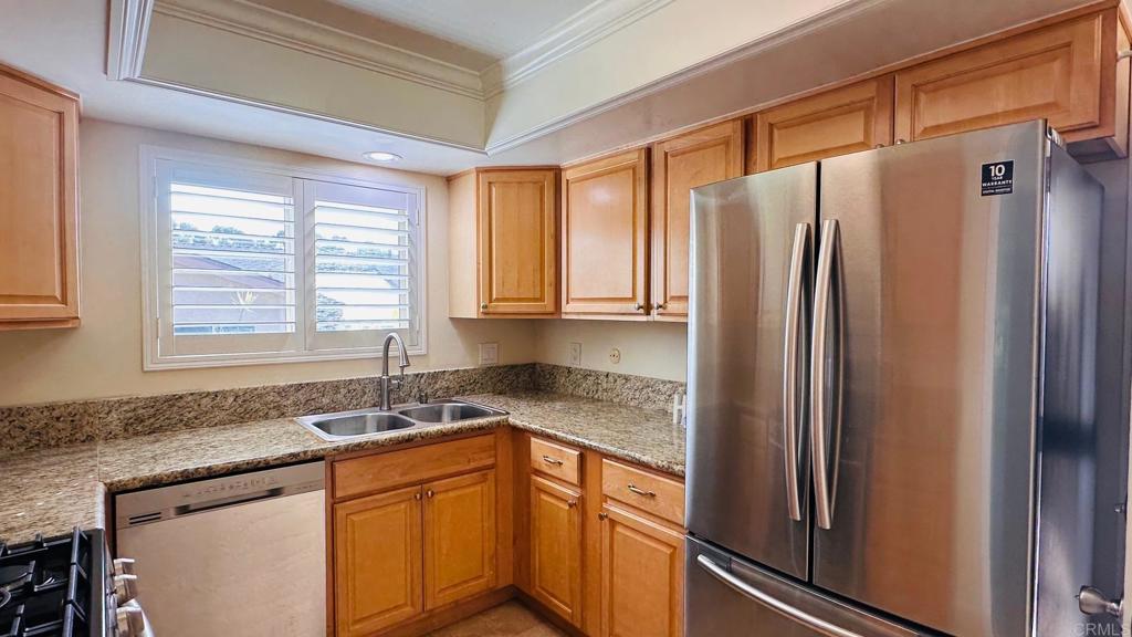 1034 Turnstone Way Oceanside, CA 92057 - Photo 4 of 25 a kitchen with stainless steel appliances granite countertop a refrigerator and a sink