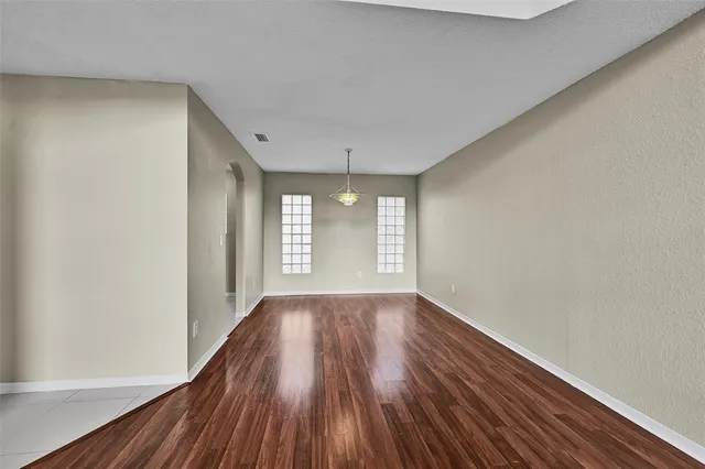 a bathroom with a granite countertop toilet sink and mirror