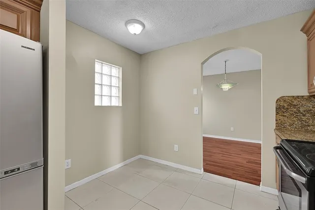 a bathroom with a granite countertop double vanity sink mirror bathtub and shower