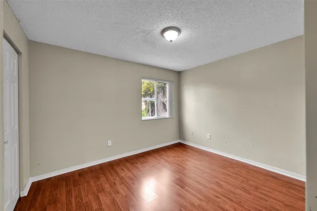 a view of a house with a yard and palm trees