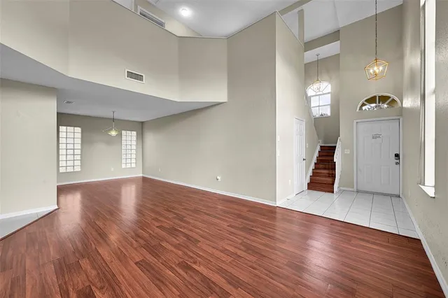 a view of wooden floor and windows in a room