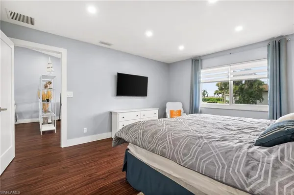 a kitchen with kitchen island a dining table chairs cabinets and stainless steel appliances