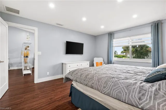 a kitchen with kitchen island a dining table chairs cabinets and stainless steel appliances