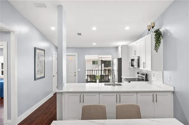 a spacious bedroom with a bed and a flat screen tv