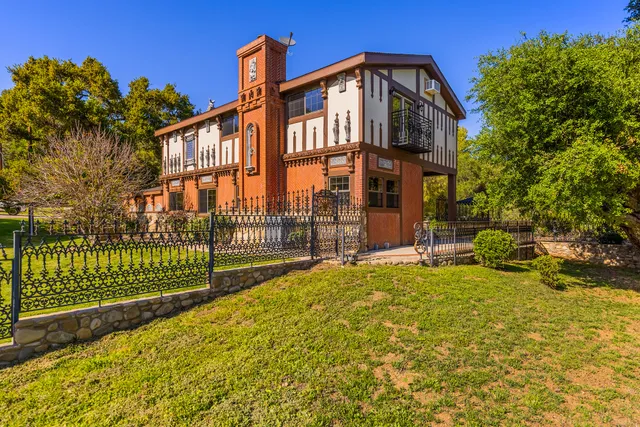 a view of a house with a iron fence