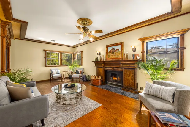 a living room with furniture a window and a fireplace