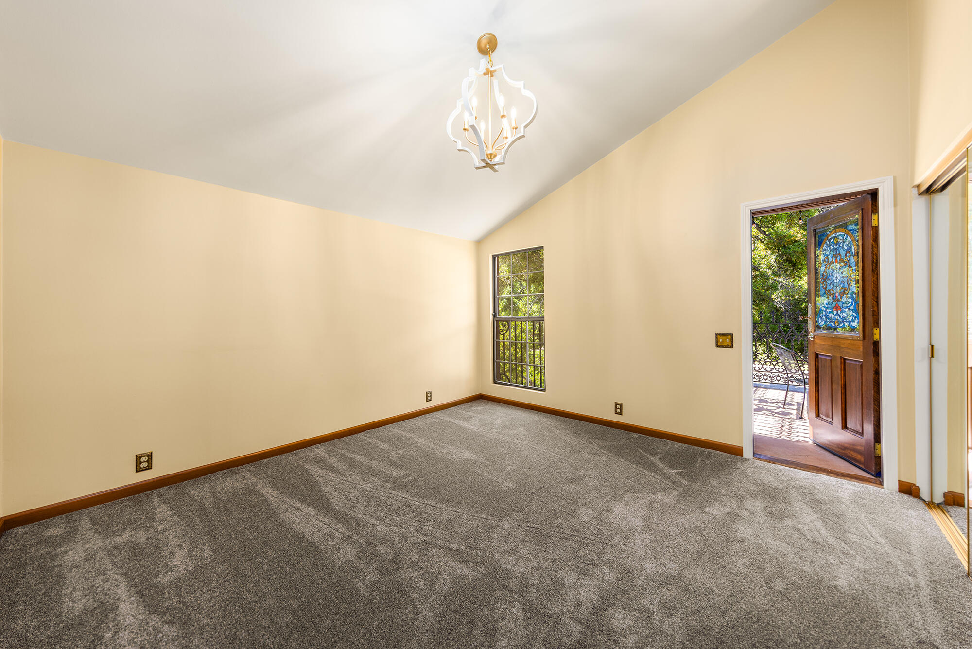 10480 Creek Road Oak View, CA 93022 - Photo 24 of 52 a view of a hallway with a chandelier fan and windows