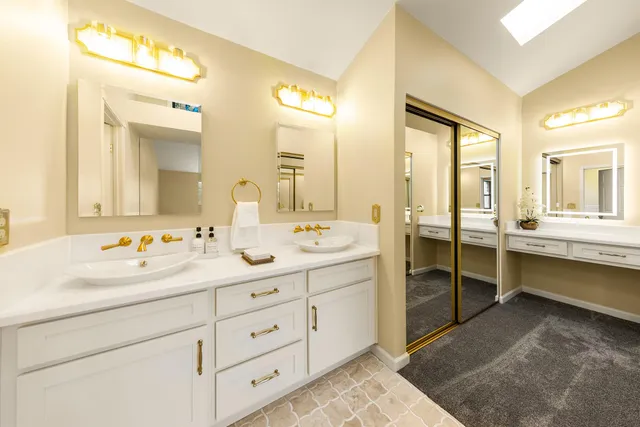 a bathroom with a double vanity sink mirror and