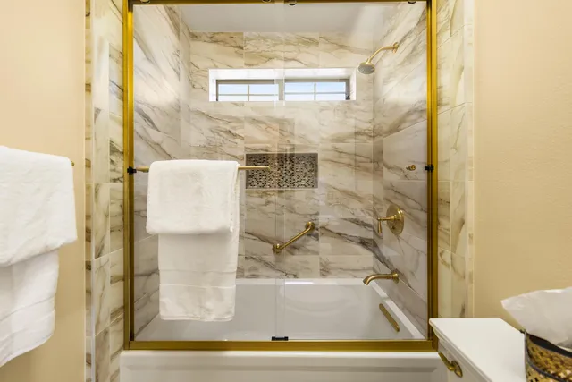 a bathroom with a bathtub and shower