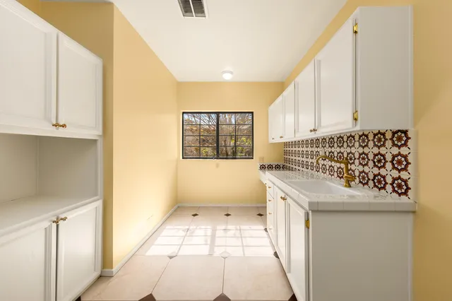 a bathroom with a granite countertop sink a toilet and a mirror
