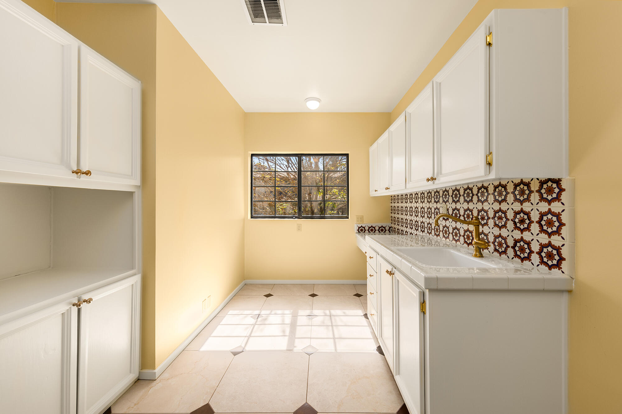 10480 Creek Road Oak View, CA 93022 - Photo 27 of 52 a bathroom with a granite countertop sink a toilet and a mirror