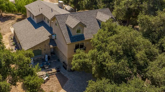 an aerial view of a house with a yard