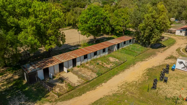 a view of a balcony with wooden floor and fence