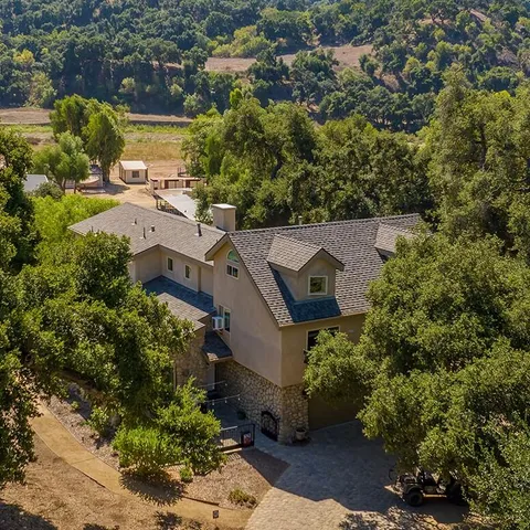 an aerial view of a house with a yard