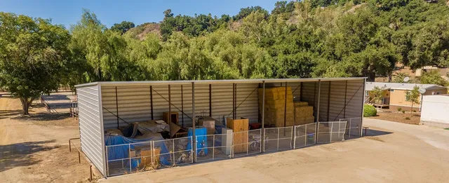 a view of a yard with wooden fence