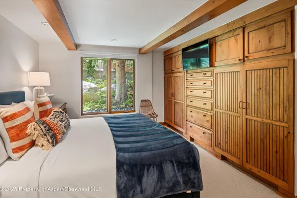 a bed room with a bed window and a dresser