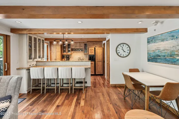 a dining room with furniture and a large window