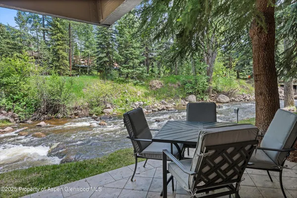 a view of a backyard with table and chairs
