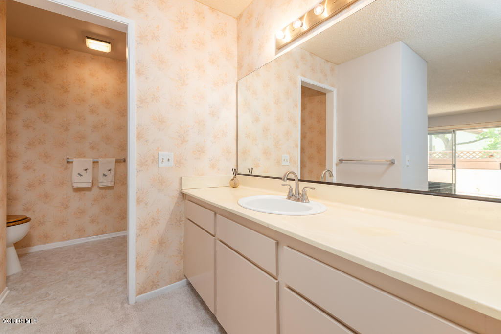 1730 Sinaloa Road, Unit 312 Simi Valley, CA 93065 - Photo 16 of 24 a bathroom with a sink and a mirror