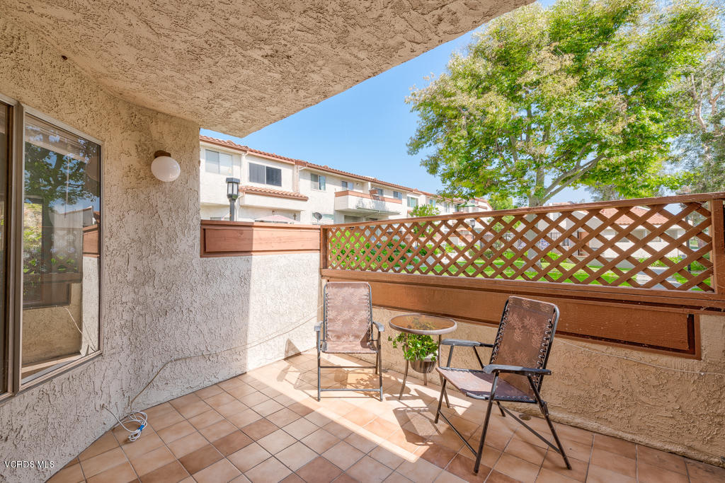 1730 Sinaloa Road, Unit 312 Simi Valley, CA 93065 - Photo 19 of 24 a backyard of a house with table and chairs