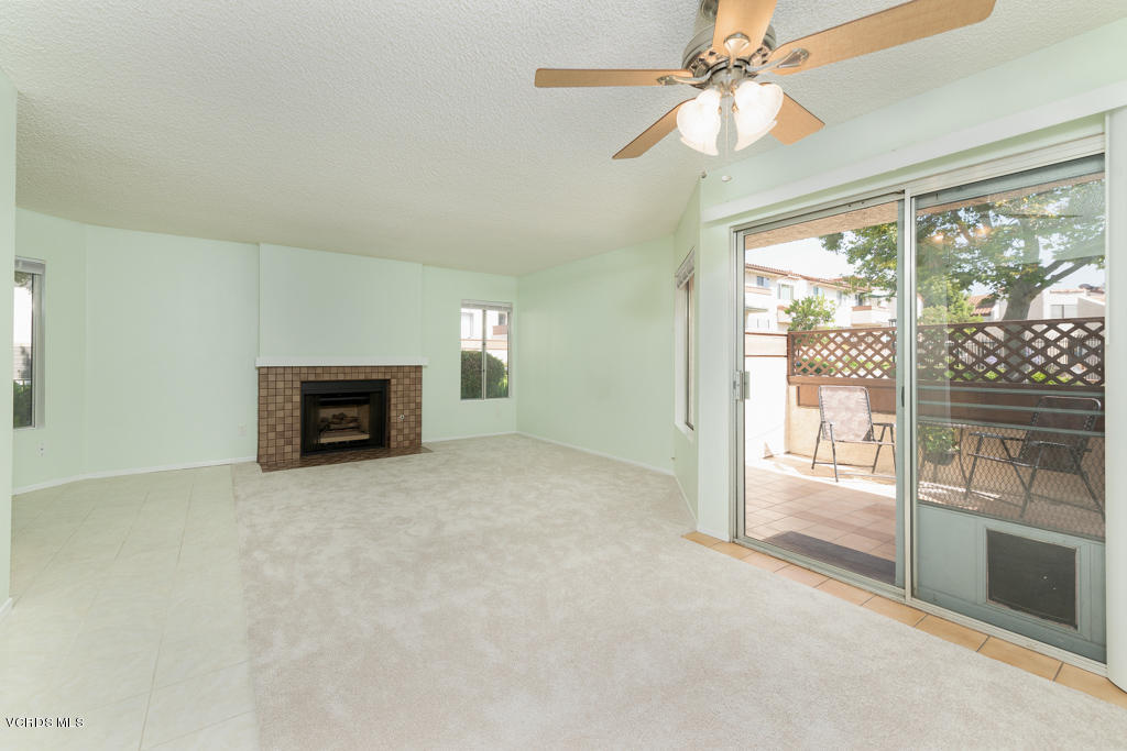 1730 Sinaloa Road, Unit 312 Simi Valley, CA 93065 - Photo 6 of 24 en empty room with windows and fireplace
