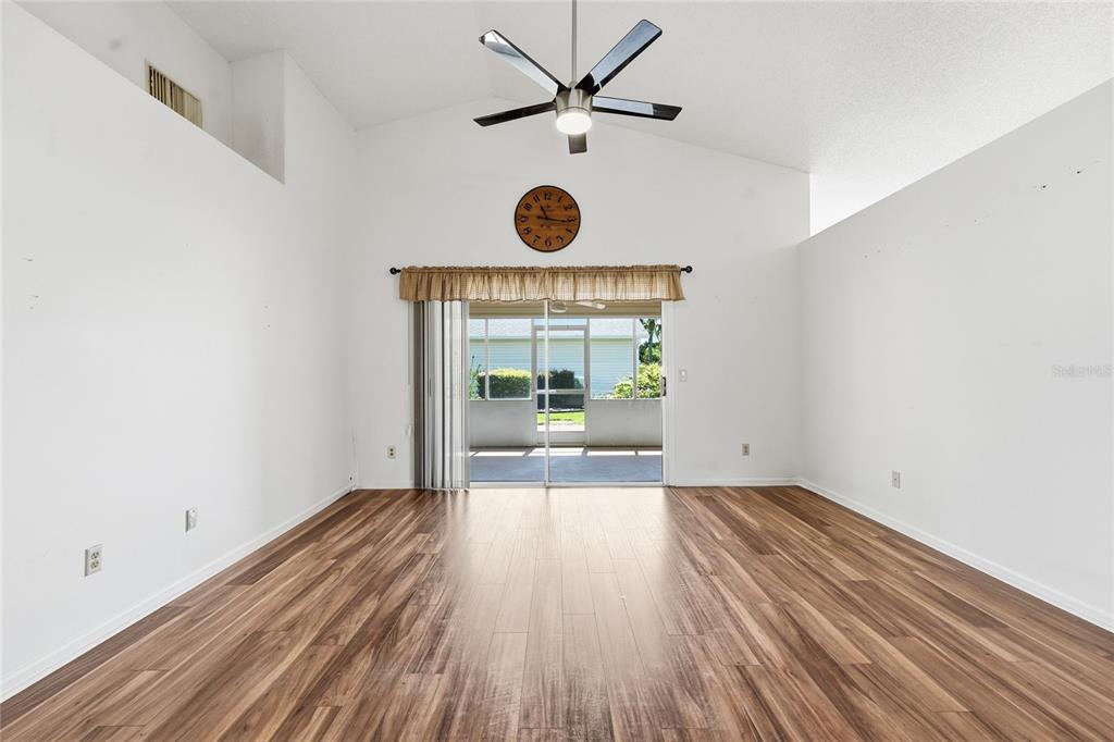 5930 Foxtail Way Fort Pierce, FL 34982 - Photo 12 of 47 a view of an empty room with wooden floor and a window