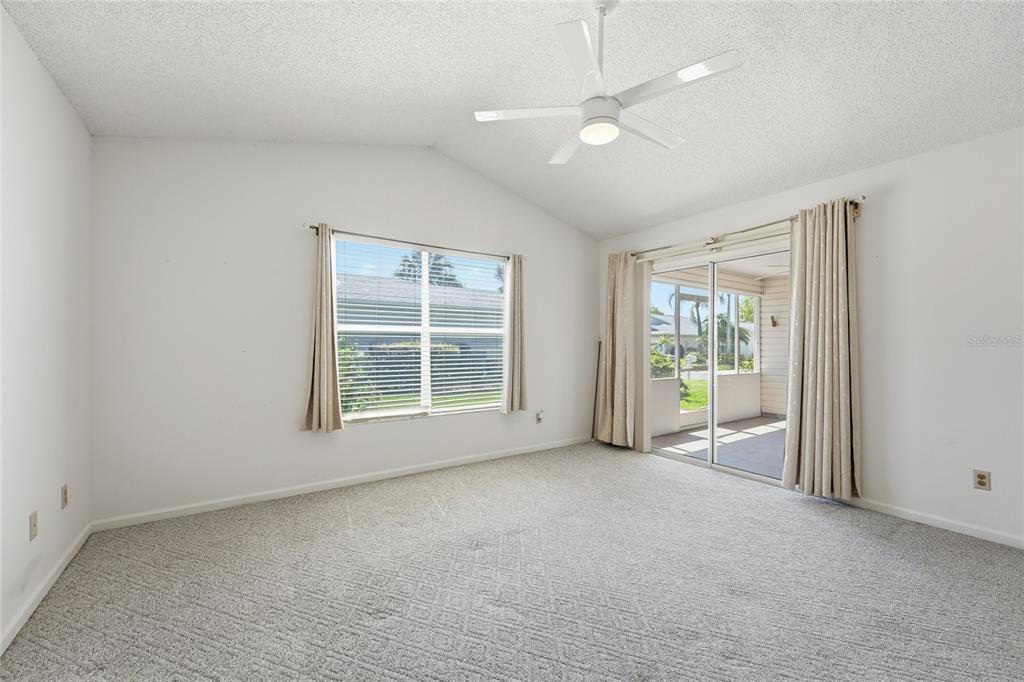 5930 Foxtail Way Fort Pierce, FL 34982 - Photo 14 of 47 an empty room with chandelier fan and windows