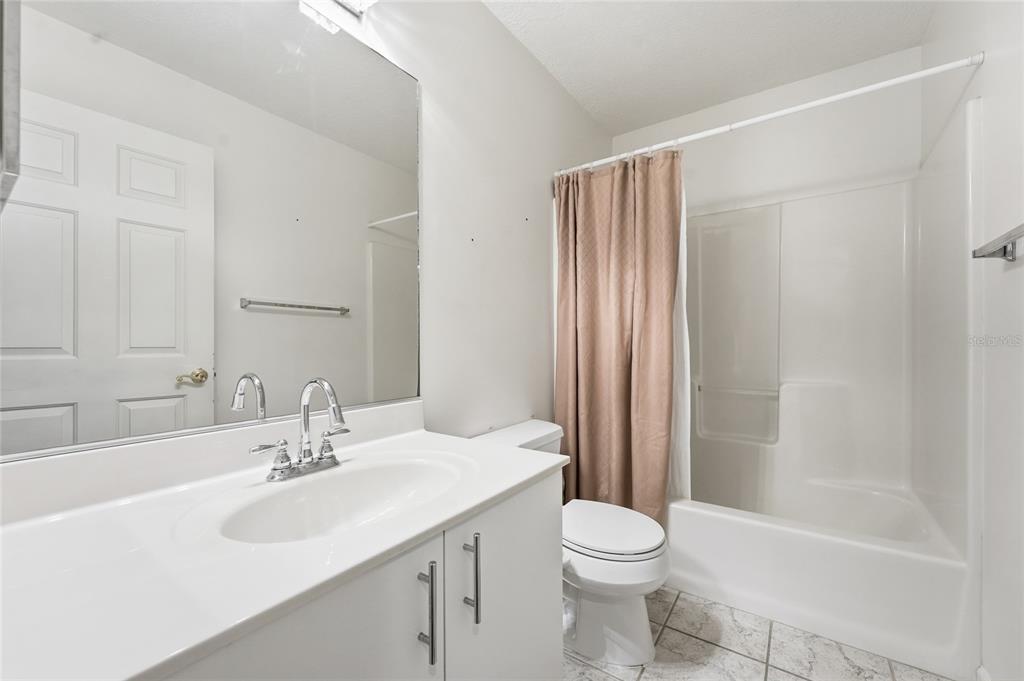 5930 Foxtail Way Fort Pierce, FL 34982 - Photo 20 of 47 a bathroom with a sink a toilet and shower