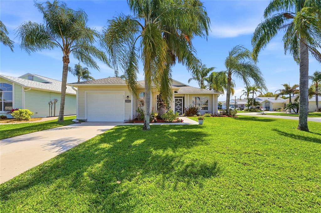 5930 Foxtail Way Fort Pierce, FL 34982 - Photo 2 of 47 a view of a yard and palm trees