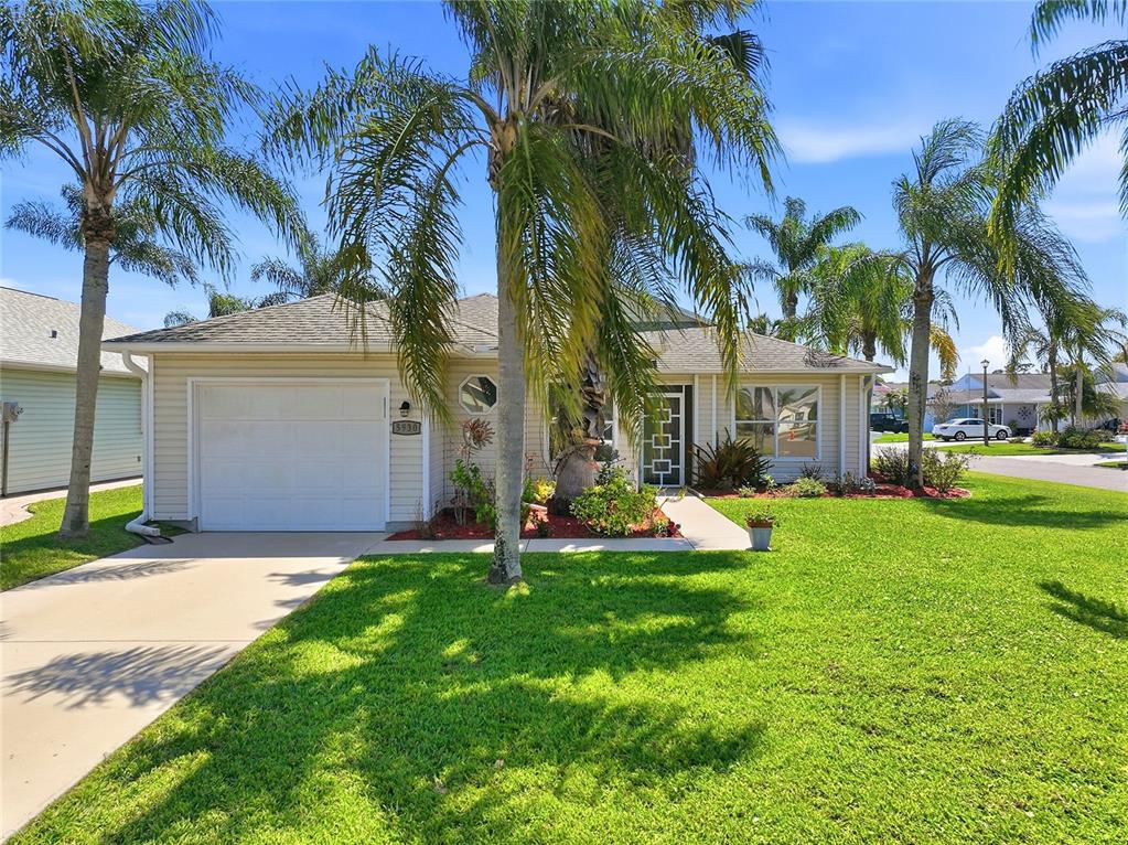 5930 Foxtail Way Fort Pierce, FL 34982 - Photo 27 of 47 a front view of a house with garden and trees