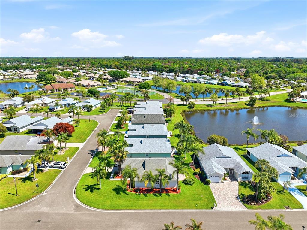 5930 Foxtail Way Fort Pierce, FL 34982 - Photo 37 of 47 an aerial view of a house with a yard and lake view