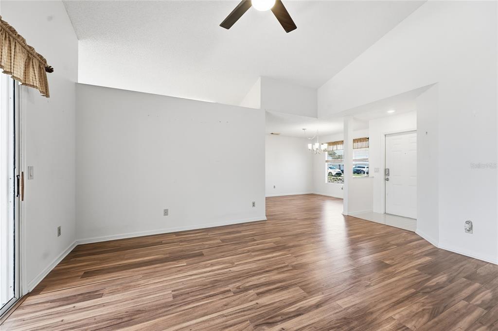 5930 Foxtail Way Fort Pierce, FL 34982 - Photo 7 of 47 a view of an empty room with wooden floor
