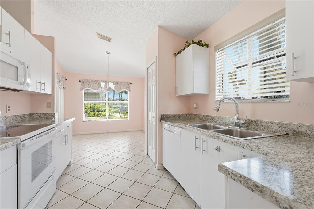 5930 Foxtail Way Fort Pierce, FL 34982 - Photo 10 of 47 a kitchen with a sink stove and cabinets