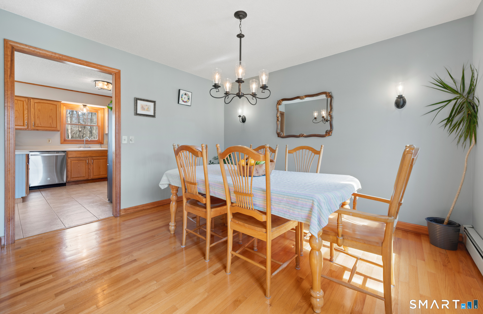 16 Gardner Tavern Road Coventry, CT 06238 - Photo 14 of 40 The dining room with hardwood flooring is open to the kitchen.