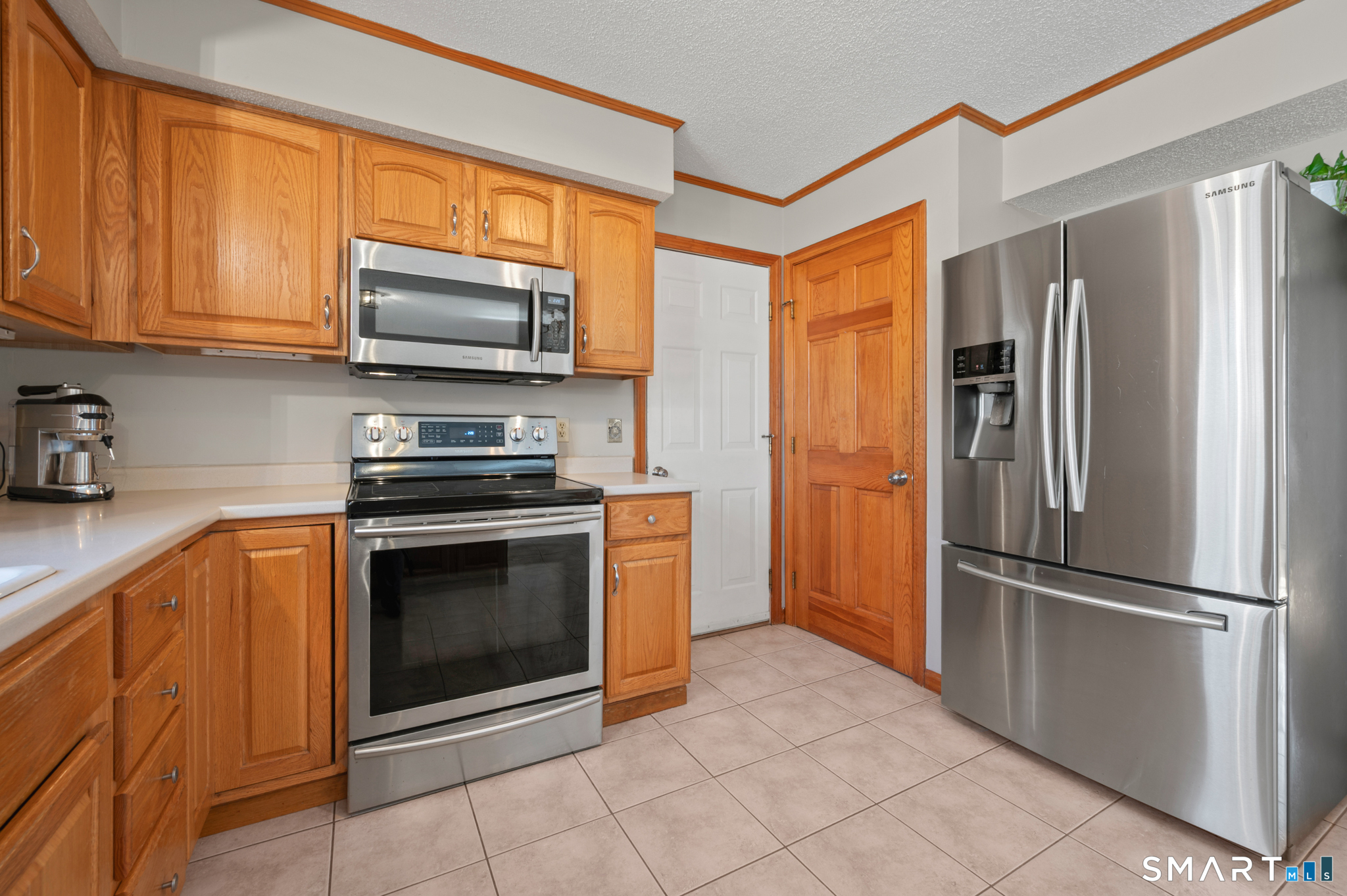 16 Gardner Tavern Road Coventry, CT 06238 - Photo 4 of 40 Pantry to the left of the refrigerator provides additional space for small appliances and kitchen basics.