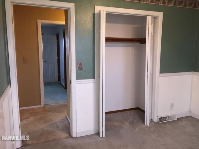 12995 Center Road Durand, IL 61024 - Photo 13 of 14 a view of an empty room with closet and a mirror