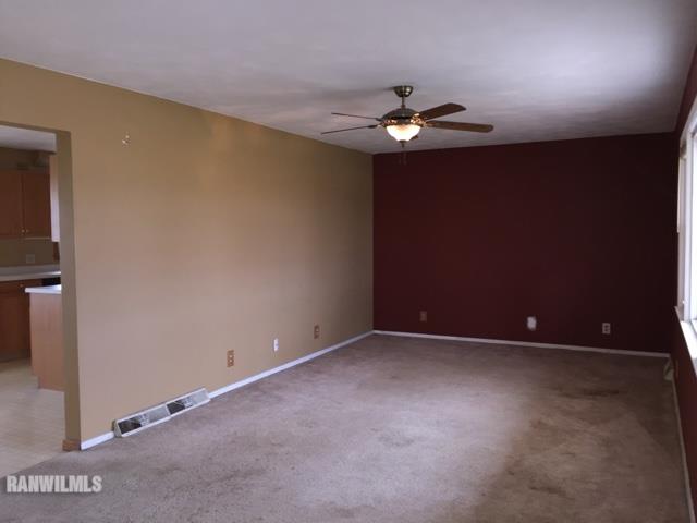 12995 Center Road Durand, IL 61024 - Photo 3 of 14 an empty room with a fan & a window