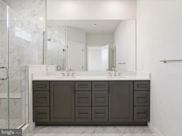 a bathroom with a shower and a sink