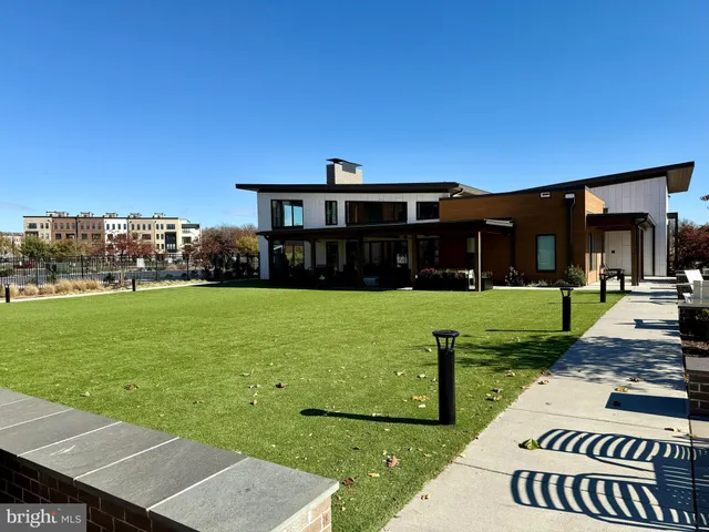a view of a house with backyard sitting area and garden