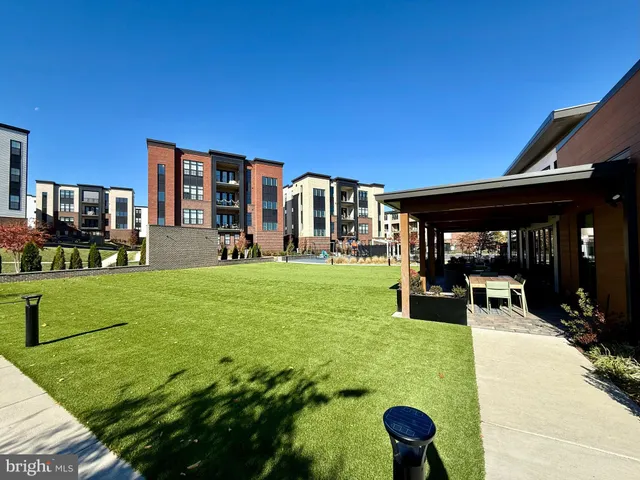a building outdoor space with patio furniture and potted plants