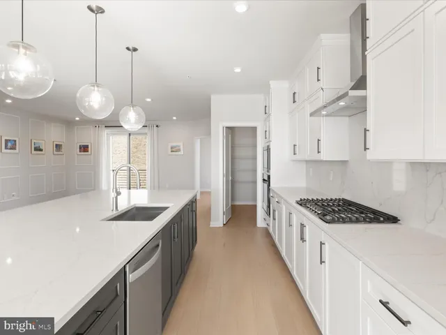 a kitchen with stainless steel appliances kitchen island a large counter space and cabinets