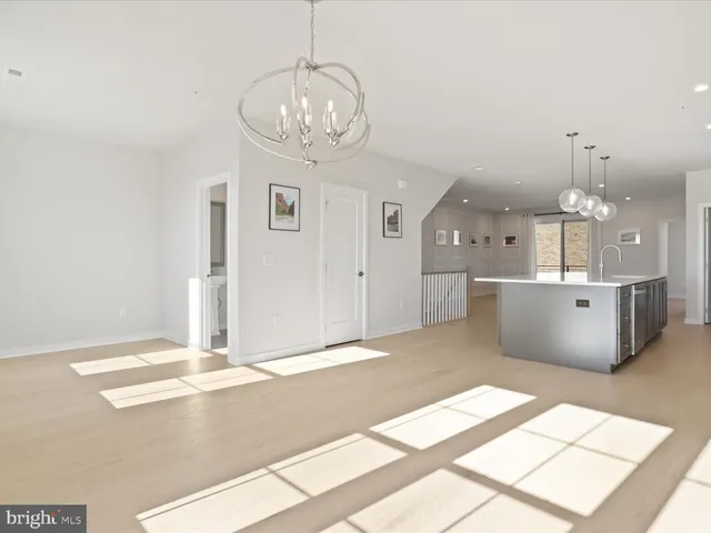 a view of a kitchen with a sink stainless steel appliances and cabinets
